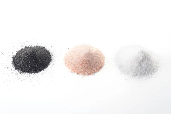 Three types of salt lie on a white background - black, pink, white — Stock Photo, Image