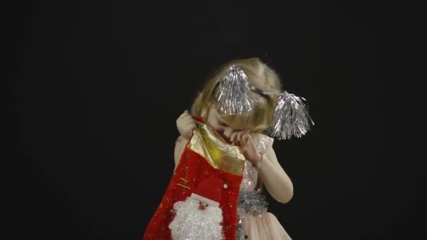 Happy beautiful little baby girl in glossy dress. Christmas. Make faces, dance — Stock Video