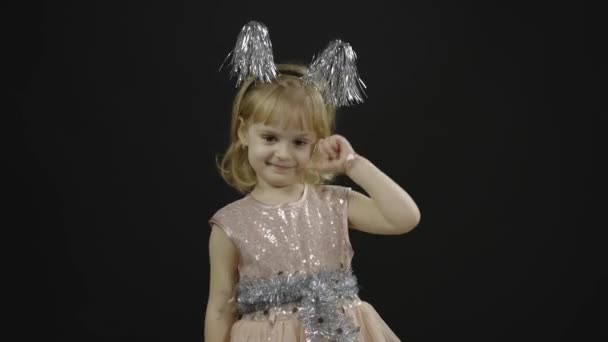 Happy beautiful little baby girl in glossy dress. Christmas. Make faces — Stock Video