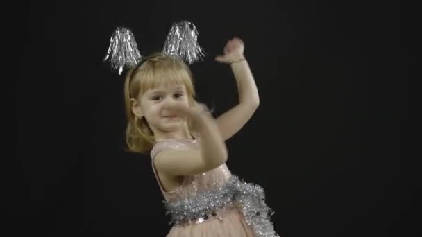 Happy beautiful little baby girl in glossy dress. Christmas. Make faces, dance — Stock Video