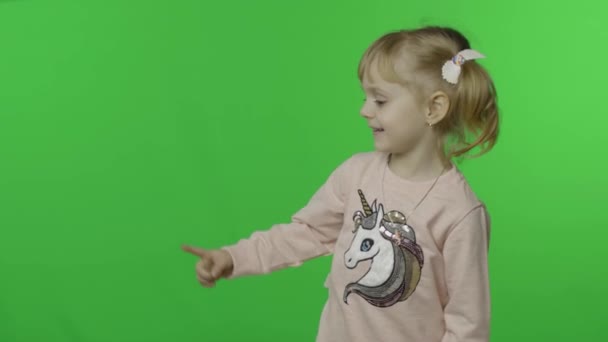 女の子でユニコーンスウェットシャツ感情的に何かで彼女の手 — ストック動画