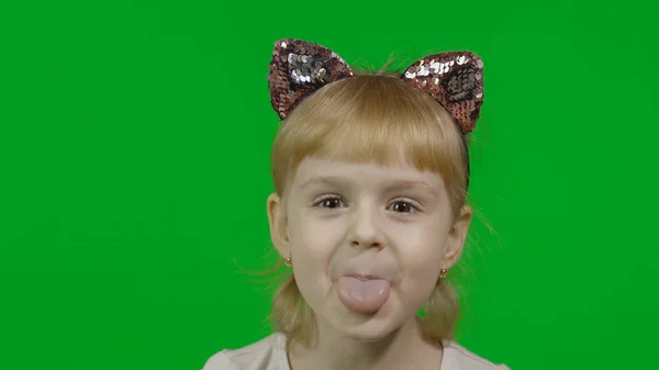 Girl in headband with a cat ears shows emotion of dissatisfied. Show tongue — Stock Photo, Image