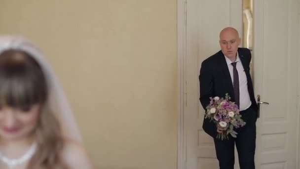 Première rencontre des jeunes mariés. Le marié va à la mariée avec un bouquet 