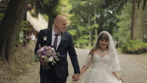 Noivo caucasiano com noiva no parque. Casamento. Família feliz. Recém-casados — Vídeo de Stock