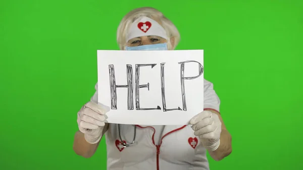 Elderly female doctor in medical mask show page with message. Coronavirus — Stock fotografie