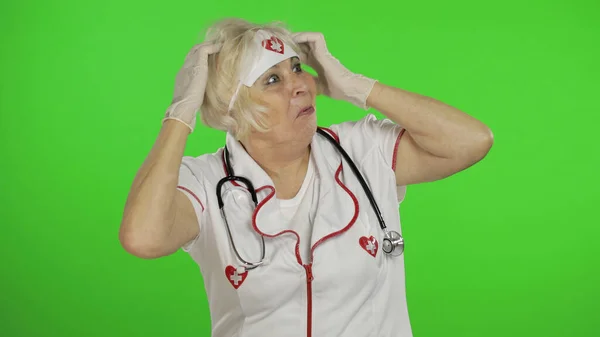 Portrait of elderly caucasian female doctor. Crazy and funny nurse — ストック写真