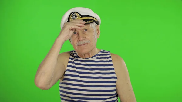 Elderly sailor man with mustache smiling. Old sailorman on chroma key — Stockfoto
