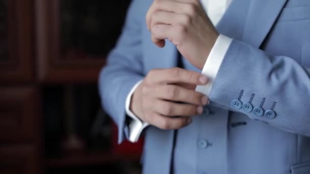 Groom adjusts shirt sleeves. Preparing to go to the bride. Businessman. Wedding — 图库视频影像