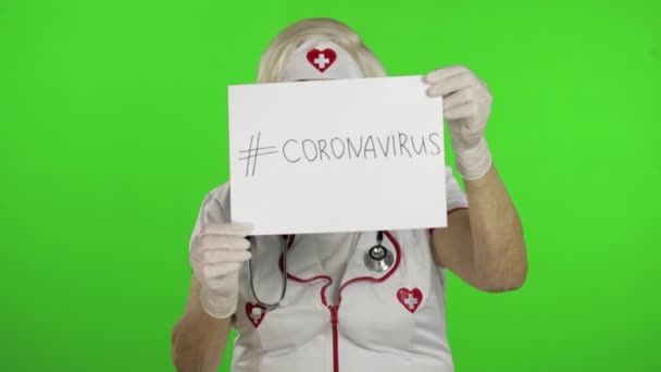 Elderly female doctor in medical mask show page with message. Coronavirus — ストック動画