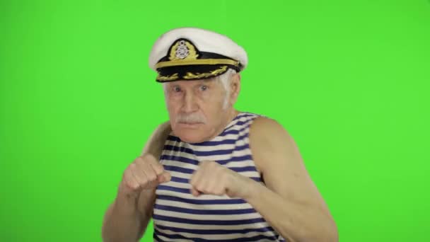 Elderly sailor man is angry and shows a fists. Sailorman on chroma key — Stock video