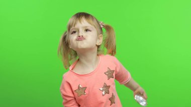 Olumlu kız duygusal olarak yüzler yapar ve pembe bluz içinde gülümser. Krom Anahtar