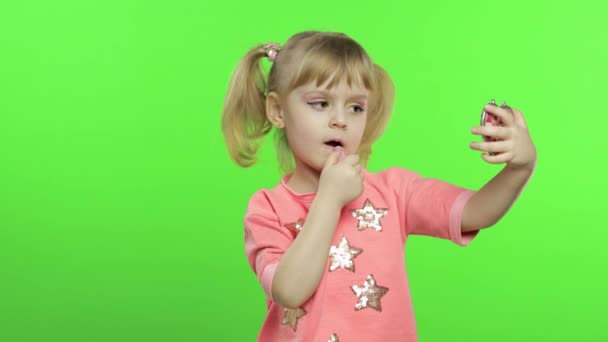 Caucasian girl on chroma key background applying red lipstick. Cosmetics, makeup — 비디오