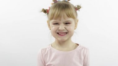 Olumlu kız duygusal olarak yüzler yapar ve pembe bluz içinde gülümser. Beyaz arkaplan