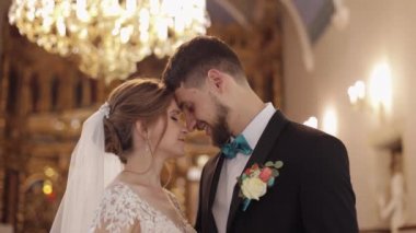 Yeni evliler. Beyaz gelin ve damat eski bir kilisede bir arada. Düğün.