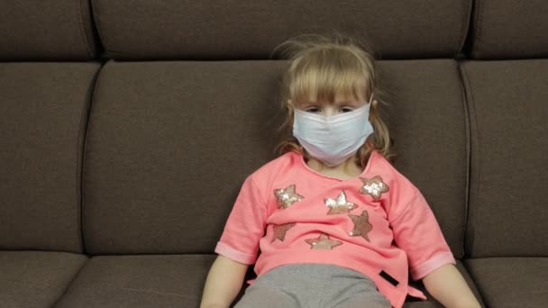 Concept of sick little girl wearing a medical mask. Quarantine. Coronavirus — Stock Video