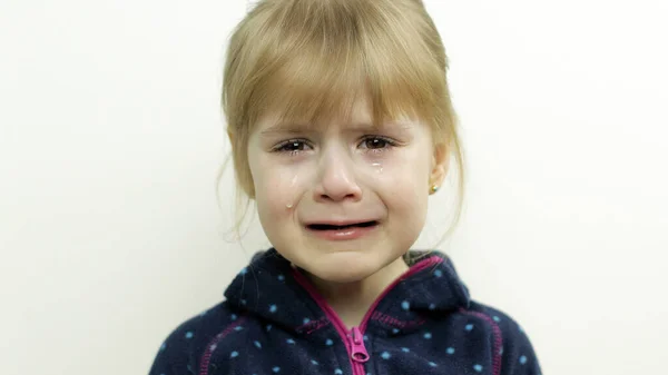 Portrait of little child girl crying with tears on her eyes. White background — Stock Photo, Image