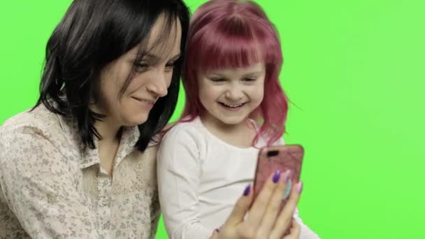 Mother, daughter holding, using smart phone talking on video call. Social media — Stock Video