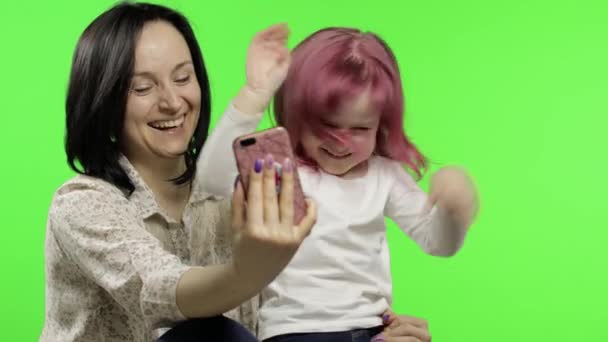 Mother, daughter holding, using smart phone talking on video call. Social media — Stock Video