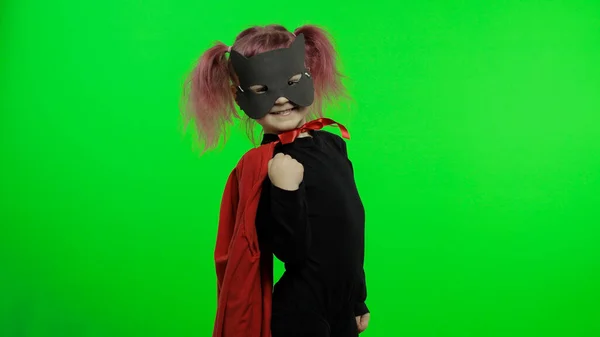 Funny child girl in costume and mask plays super hero. National superhero day — Stock Photo, Image