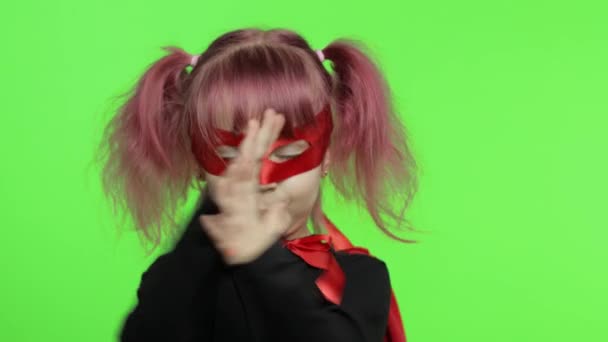 Funny child girl in costume and mask plays super hero. National superhero day — Stock Video