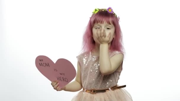 Child girl princess holds pink paper heart with text about mother. Mothers day — Stock Video