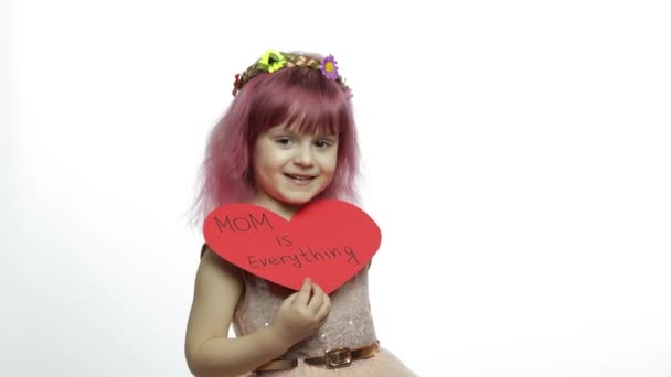 Niña princesa sostiene corazón de papel rojo con texto sobre la madre. Día de las madres — Vídeo de stock