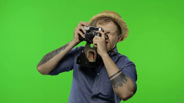 Портрет туриста-фотографа снимает на камеру. Ключ хрома — стоковое фото