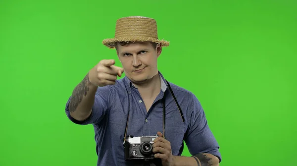 Portrait of young man tourist photographer pointing finger at camera. Chroma key — Stock Photo, Image