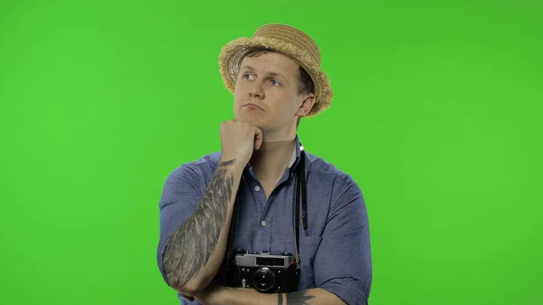 Portrait of young man tourist photographer thinking. Chroma key