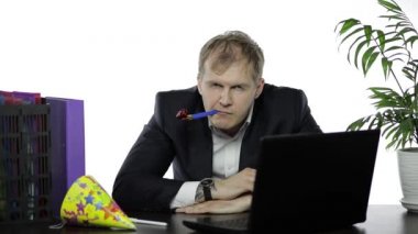 Masada yatarken ıslık çalan uykulu genç bir işadamı. Akşamdan kalma.