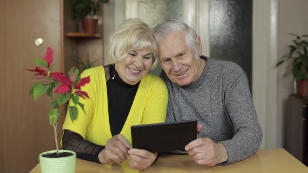 Pretty mature senior couple grandparents making video call message at home — Stock Video