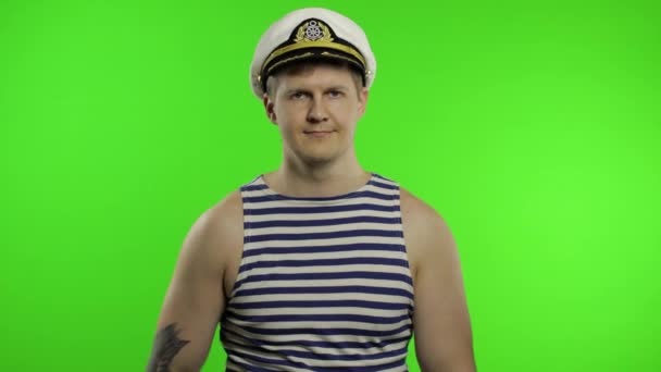 Young sailor man salutes with hand to camera. Seaman guy in sailors vest — Stock Video