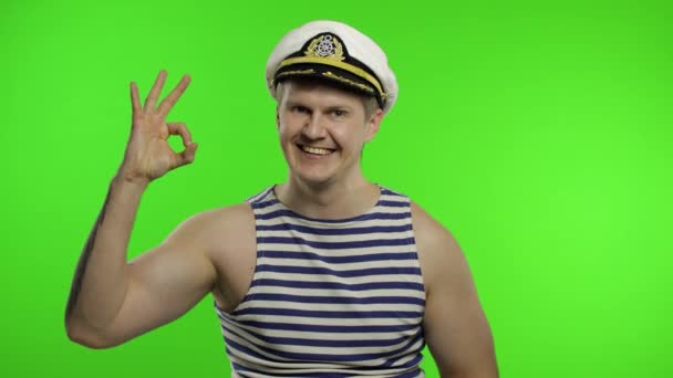 Young sailor man shows ok sign, looking at camera. Seaman guy in sailors vest — Stock Video