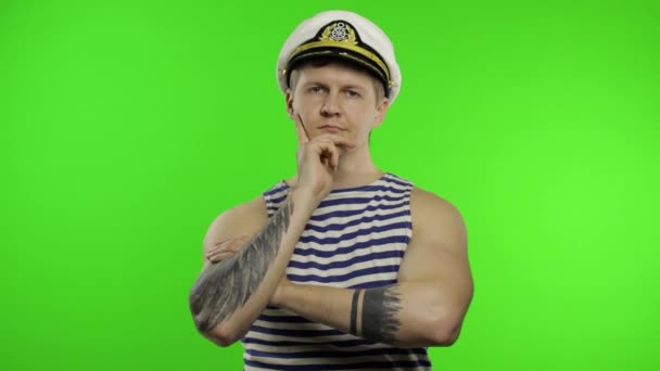 Young sailor man thinks and gets a great idea. Seaman guy in sailors vest — Stock Video