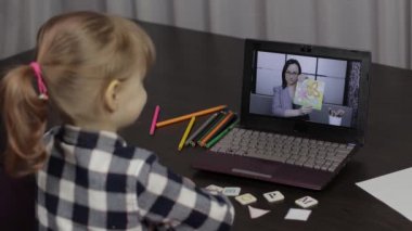 Dizüstü bilgisayarla çocuklara uzaktan eğitim. Evde kadın öğretmenle çevrimiçi ders.