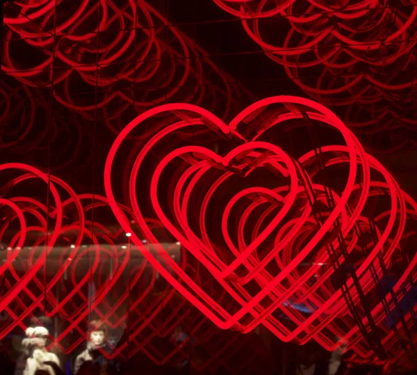 Infinite hearts background: love, passion and Valentine Day theme. Projection on a glass. Heart symbol. Romantic. Passion