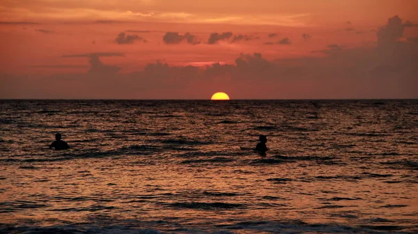 Jouer sur la plage au crépuscule, prise quand la lumière est très faible — Photo