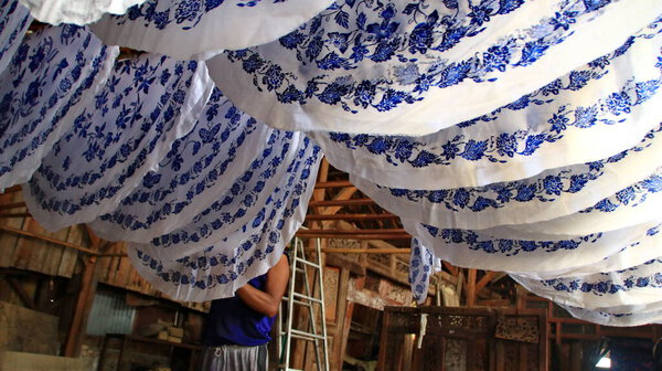  Activity of making batik,  Create and design white fabric using canting and malam by slamming over the fabric, Pekalongan, Indonesia, March 7, 2020