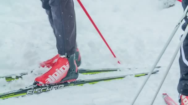 一个穿着红色滑雪靴的人在雪地上走得很慢 — 图库视频影像