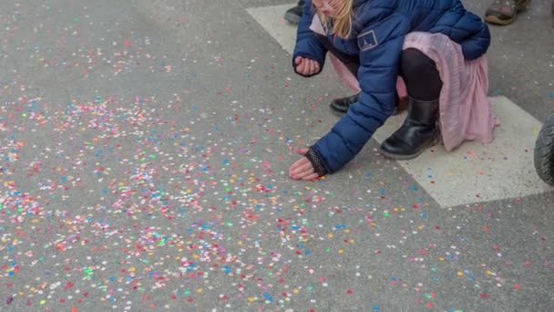 Een Meisje Pikt Confetti Van Grond Een Groot Festival Met — Stockvideo