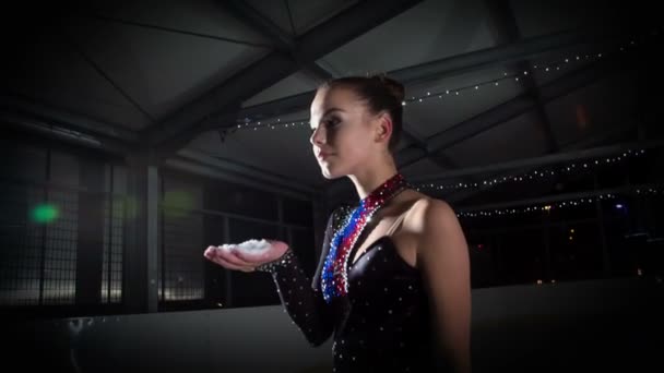 Figure Skater Blows Ice Her Hand — Stock Video