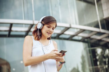 Genç kadın müzik dinliyor.