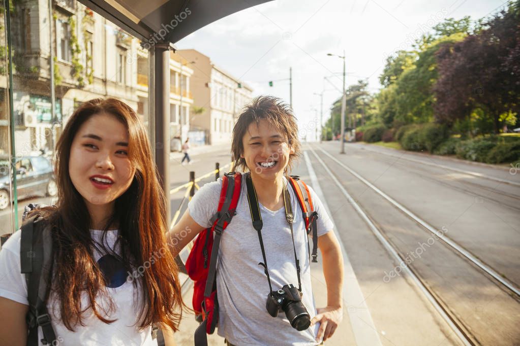 Young Asian Tourists at tram stop