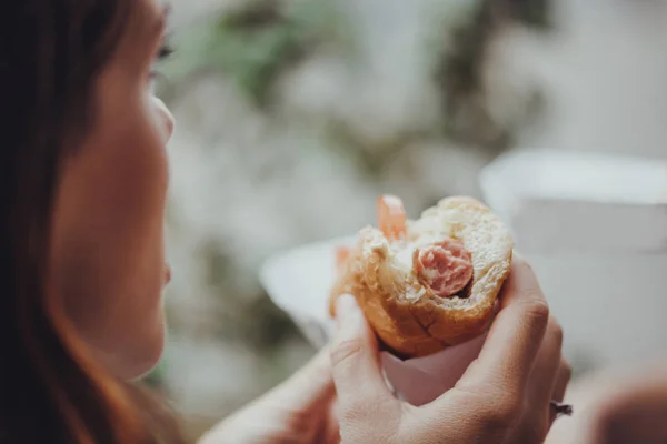 Giovane donna mangiare un hotdog — Foto Stock