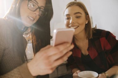 İki kız bir Smartphone kullanarak