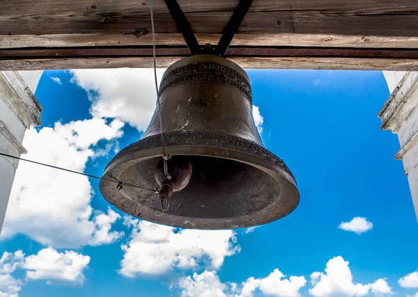 The bell in the Russian Orthodox Church. Background of blue sky and clouds.