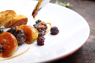 Tabakların stilize edilmesi. Kızarmış tavuk ciğeri ile ahududu ve böğürtlen meyvesi. Karamelli elma ve kıtır ekmekle servis ediliyor.