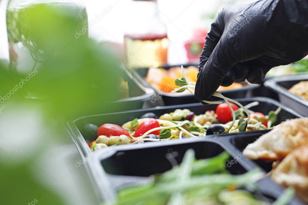 Meal prep containers, the chef prepares a meal in a boxed diet delivered to order.