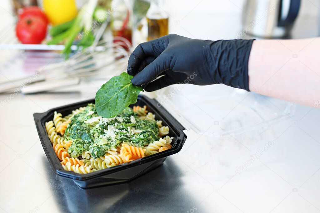 Meal prep. Box diet, healthy balanced meals. Appetizing pasta with spinach and cream cheese sauce.