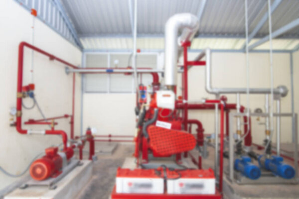 Industrial blurred,Water pressure control room,Several water pumps with large electric motors,Modern industrial boiler room.Water treatment pipes and pressure gauges installed for pressure control.